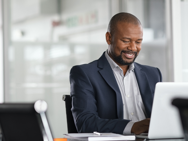 mature African American business man reviewing important document in an office