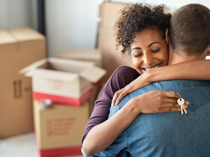 young diverse couple hugging in a new house